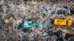 Garbage pile in trash dump or landfill, Aerial view garbage trucks unload garbage to a landfill